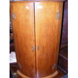 A 19th century oak bow front hanging corner cabinet