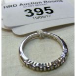 An 18ct white gold diamond half hoop eternity ring