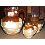 Three graduated Doulton Lambeth stoneware hunting jugs with silver mounts