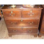 A 19th century oak chest of two short and two long drawers, with brass handles and escutcheons