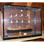 A wooden model of a four masted sailing ship in 61cm perspex case