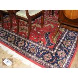 A 244cm x 242cm red ground Middle Eastern rug