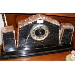 An Art Deco marble mantel clock with matching pedestals on wooden base