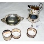 Pierced silver two handled dish, silver cream jug and three ditto napkin rings