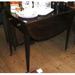 A George III mahogany Pembroke table with cross banded top and single drawer