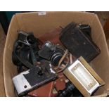 A box containing various makes of camera lenses