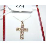 A gem set 9ct gold cross and chain in presentation box