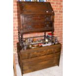 An antique oak bureau, together with an antique style oak chest of drawers