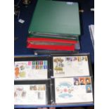 Four folders of commemorative First Day Covers, together with an album of collectable stamps