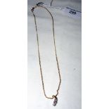 A 9ct gold three stone diamond pendant and chain