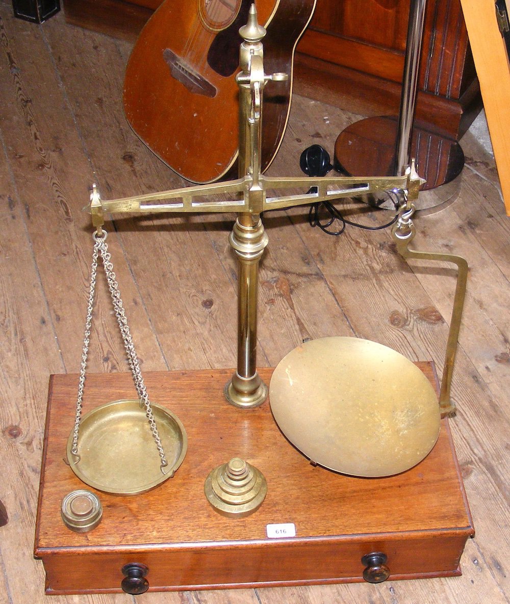 A set of large brass and mahogany balance scales with weights