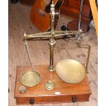 A set of large brass and mahogany balance scales with weights