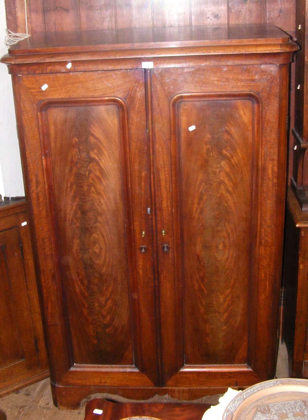 A small proportioned French two door wardrobe with slides to interior