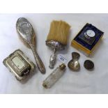 A silver cased bedside travel clock, silver back dressing table brushes, etc.