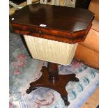 A 19th century mahogany worktable with fitted interior and carved paw feet