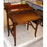 An unusual writing desk with hinged top and brown leather slide