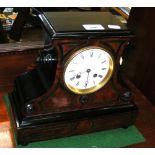 A walnut and ebonized cased striking mantel clock with white enamel dial and Roman numerals