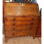 Antique oak bureau with cross banded fall front and drawers on bracket feet