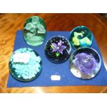 A Caithness flower paperweight, together with four others