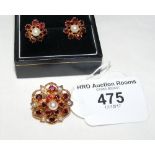 A suite of jewellery comprising clip brooch and earrings in garnet and pearl