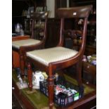 A set of four Victorian dining chairs with curved backrest and turned front supports