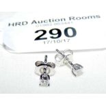 A pair of diamond stud earrings in presentation box