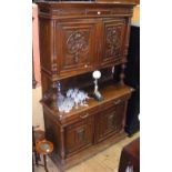 A French carved oak sideboard with panelled doors to the top, drawers and cupboards below - 140cm