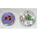 A Whitewood floral paperweight, together with one other of fish