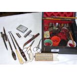An antique jewellery box containing various collectables, including button hooks, etc.