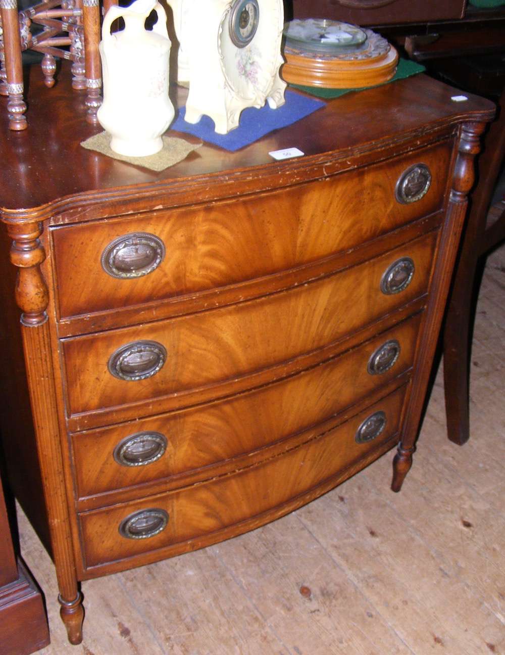 Bow fronted mahogany chest of four long drawers - 70cm wide