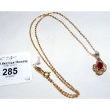 An 9ct gold ruby and diamond pendant on 18ct gold fine link chain