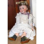 An antique bisque head doll with composite body, the head stamped Jutta 1914, having original doll's