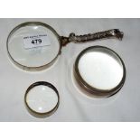 A silver magnifier with "Leopard" handle and two others