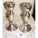 A pair of 15cm high silver candlesticks