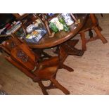Arts and Crafts style oak dining table and the matching set six chairs with Lion's rampant to the