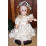 An antique bisque head doll with composite body, the head stamped SH - 914 - 65cm