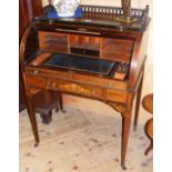 An Edwardian inlaid rosewood lady's cylinder writing desk with fitted interior and sliding mechanism