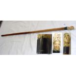 An antique malacca walking cane with carved double head handle and silver mount
