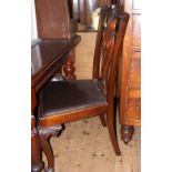 A set of four Chippendale style mahogany dining chairs with carved cabriole front supports