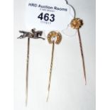Two seed pearl mounted gold stickpins and a diamond mounted jockey on horseback ditto