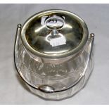 A faceted glass biscuit barrel with 925 marked continental lid, mount and handle