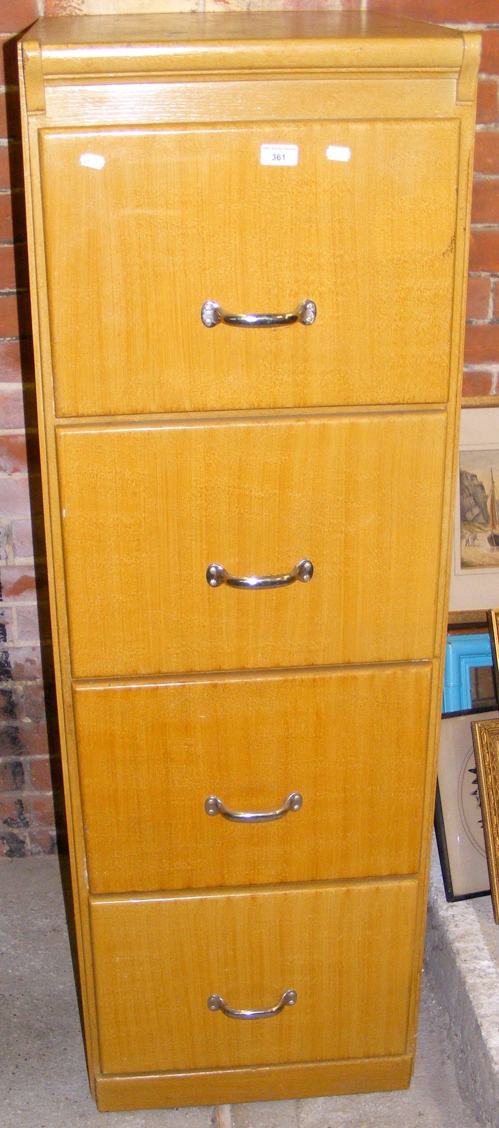 An antique four drawer filing cabinet
