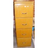 An antique four drawer filing cabinet