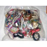 A large bag of assorted costume jewellery