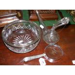 A silver rimmed bowl, oil decanter and magnifying glass