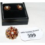 A suite of jewellery comprising clip brooch and earrings in garnet and pearl