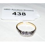 A diamond three stone ring in 18ct gold setting