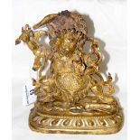 A Sino-Tibetan gilt bronze Mahakala, the deity atop a prone elephant headed figure, holding sword