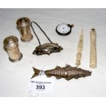 A white metal articulated fish, pepper pot, etc.