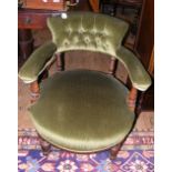 A Victorian tub chair with button back and turned front supports